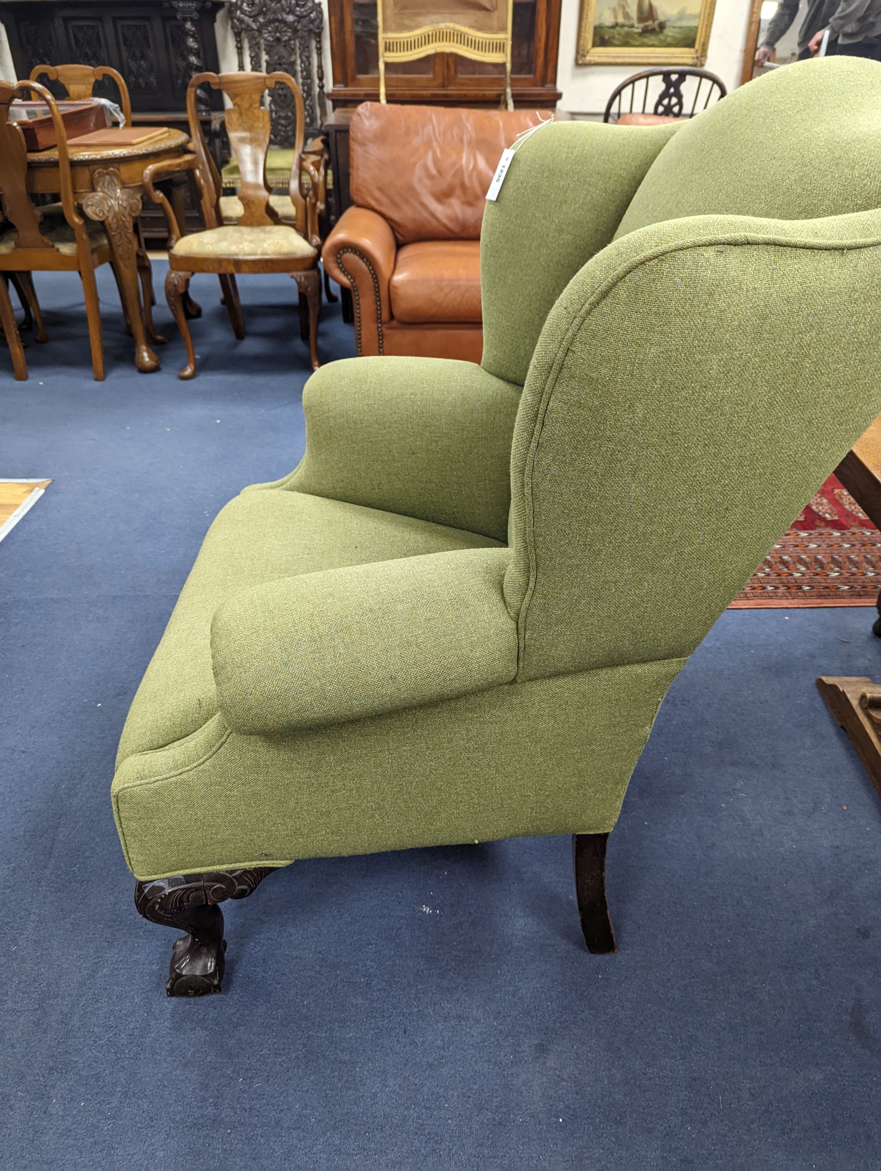 A George III style wing armchair upholstered in green wool fabric, width 86cm, depth 80cm, height 111cm